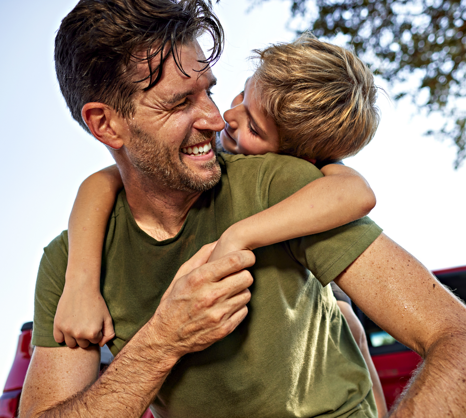 A father and son hugging after dad returns home from the work day