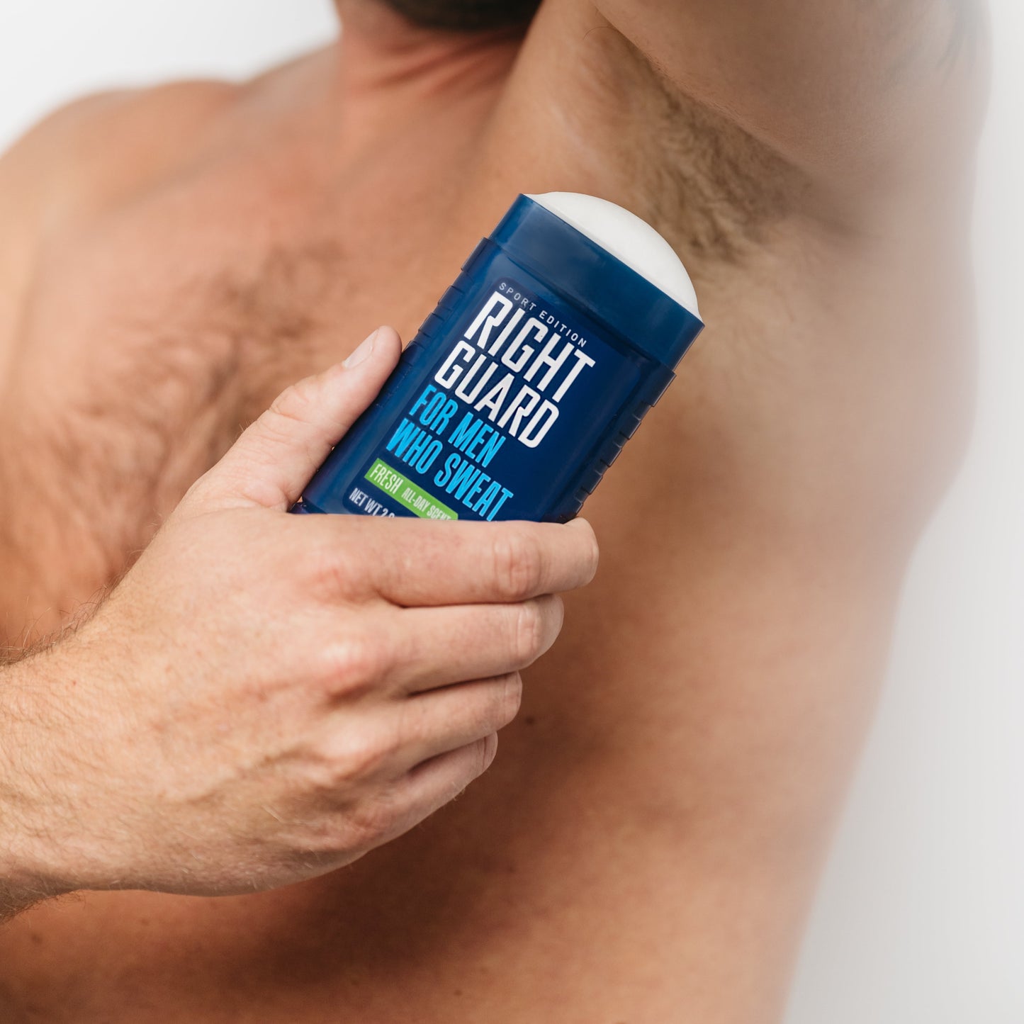 Man applying Right Guard sport invisible solid antiperspirant and deodorant